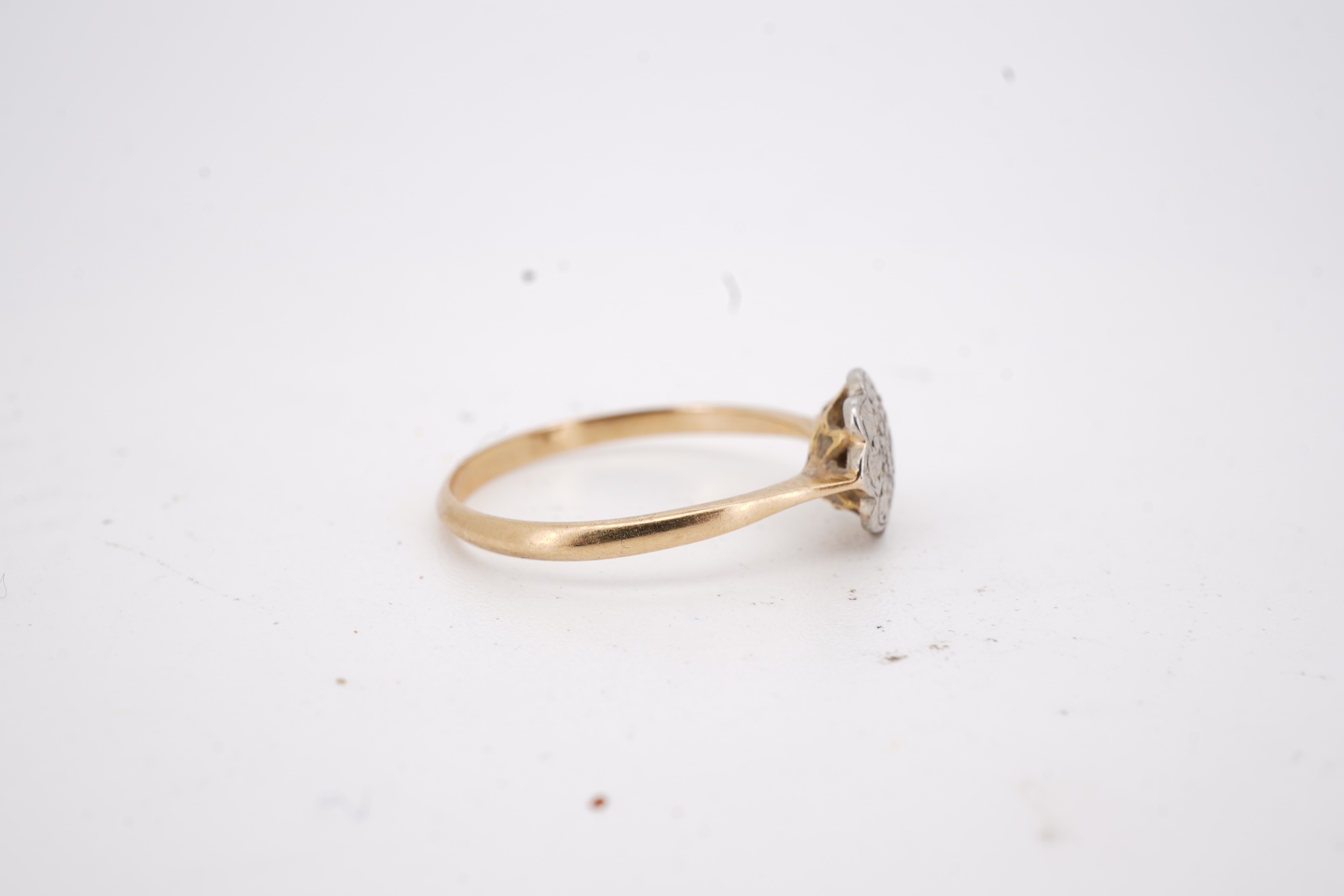 Three rings, comprising: a platinum wedding band, size N1/2, stamped PLAT, gross weight 3 grams; a bicoloured band, size J, stamped PLATINUM 22CT, gross weight 3 grams; and a ring set with a diamond weighing approximatel